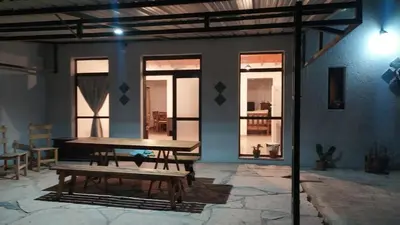 a patio with a wooden table and a bench at Indigo in Carpintería