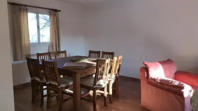a dining room with a table and chairs and a couch at Indigo in Carpintería
