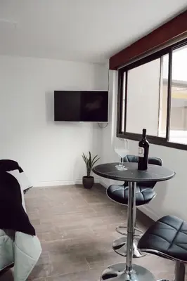 a room with a table with a bottle of wine on it at Departamento NYC 1 - Edificio VILAUT by INMOVE Temporarios in Cordoba
