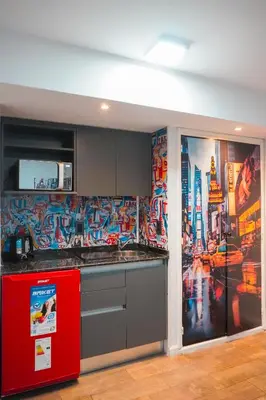 a kitchen with a red refrigerator and a mural at Departamento NYC 1 - Edificio VILAUT by INMOVE Temporarios in Cordoba