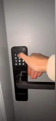 a persons hand is unlocking a refrigerator door at Departamento NYC 1 - Edificio VILAUT by INMOVE Temporarios in Cordoba