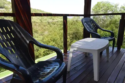 two chairs and a white table on a porch at Moradillo Apart in La Cuesta