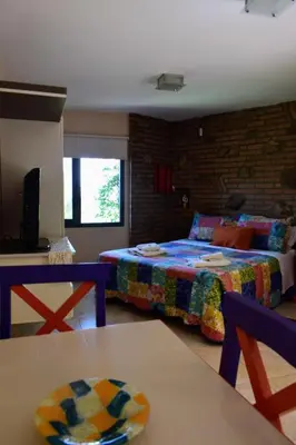 a living room with two beds and a table at Moradillo Apart in La Cuesta