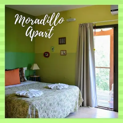a bedroom with a bed and a sign that reads magnolia agent at Moradillo Apart in La Cuesta