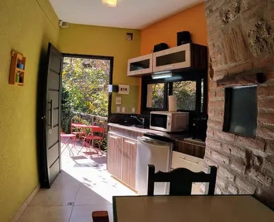 a kitchen with yellow walls and a door leading to a patio at Moradillo Apart in La Cuesta