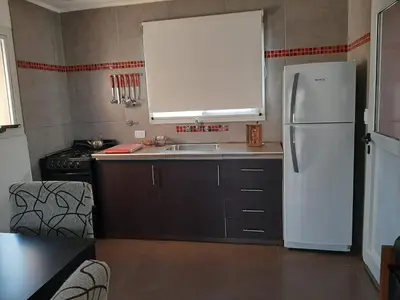 a kitchen with a white refrigerator and a sink at Indigo CCH in Carpintería