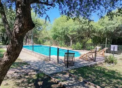 a swimming pool in a park with a tree at Indigo CCH in Carpintería