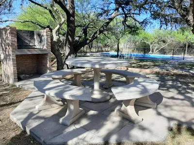 a picnic table and benches in a park at Indigo CCH in Carpintería