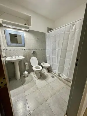 a bathroom with two toilets and a sink at ACOGEDOR Dpto Pasaje Tucumán in Alta Gracia