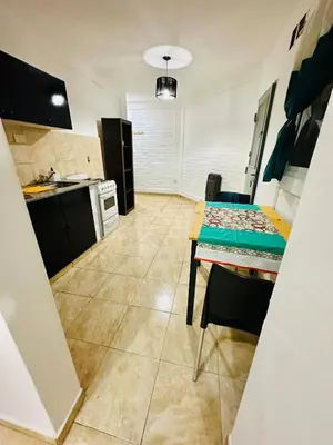 a kitchen with a table and a dining room at ACOGEDOR Dpto Pasaje Tucumán in Alta Gracia