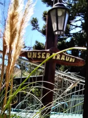 a street sign on a street light with tall grass at Unser traum in Villa General Belgrano