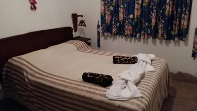 a bed with towels and shoes on top of it at Unser traum in Villa General Belgrano