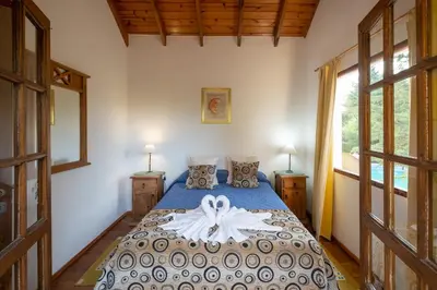 a bedroom with a bed with a dress on it at LAS PRINCESAS Cabañas frente al rio in Los Reartes