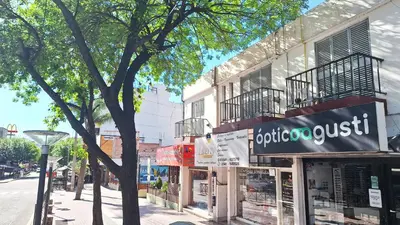 a store with a sign on the side of a street at Departamentos Buena Onda in Villa Carlos Paz