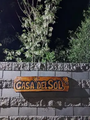 a sign on top of a brick wall at Casa del Sol in Santa María