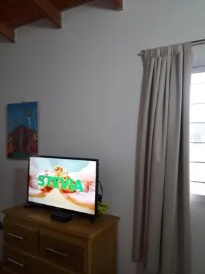 a flat screen tv sitting on top of a dresser at Casa del Sol in Santa María