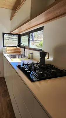 a kitchen counter with a stove top in a kitchen at Colores de Manantiales in Villa General Belgrano