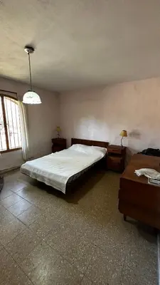 a bedroom with a large bed and two night stands at Casa grande 5 pax San Antonio de Arredondo CORDOBA in San Antonio de Arredondo
