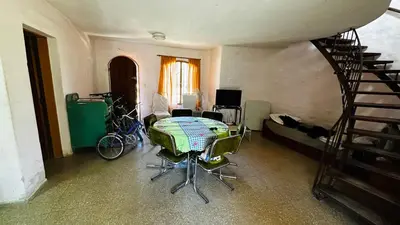 a room with a table and chairs and a staircase at Casa grande 5 pax San Antonio de Arredondo CORDOBA in San Antonio de Arredondo