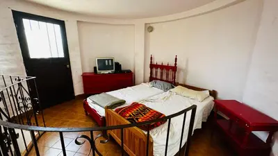 a bedroom with a bed and a television in it at Casa grande 5 pax San Antonio de Arredondo CORDOBA in San Antonio de Arredondo