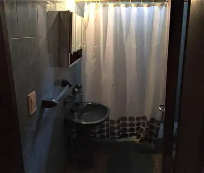 a bathroom with a sink and a shower curtain at Casa grande 5 pax San Antonio de Arredondo CORDOBA in San Antonio de Arredondo
