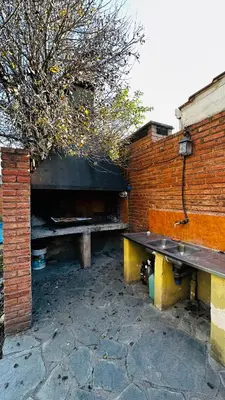 two benches sitting next to a brick wall at Casa grande 5 pax San Antonio de Arredondo CORDOBA in San Antonio de Arredondo
