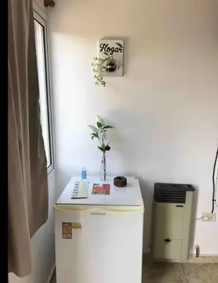 a white refrigerator in a kitchen with a plant on it at Deptos carlos paz in Villa Carlos Paz