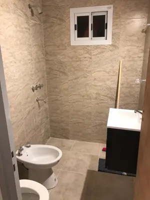 a bathroom with a white toilet and a sink at Deptos carlos paz in Villa Carlos Paz