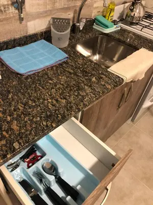 a kitchen counter with a sink and a dishwasher at Deptos carlos paz in Villa Carlos Paz