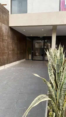 a plant in front of a building at Lake Towers Suite in Villa Carlos Paz