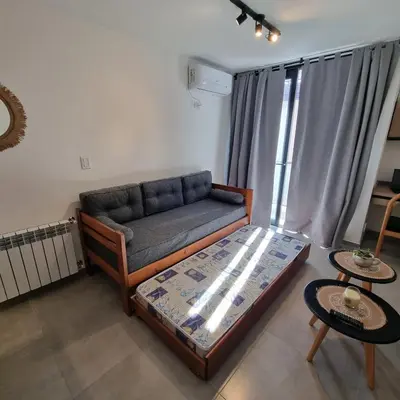 a living room with a couch and a table at Moderno Dpto Centrico in Villa Carlos Paz