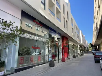 a store front of a building on a city street at Moderno Dpto Centrico in Villa Carlos Paz