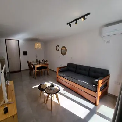 a living room with a couch and a table at Moderno Dpto Centrico in Villa Carlos Paz