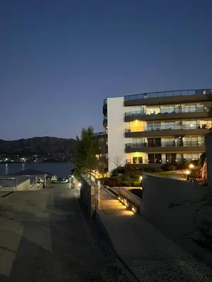 a building with lights in front of a building at Departamento Veneto Village - K - in Villa Parque Siquiman