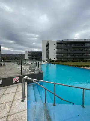 a large swimming pool on the roof of a building at Departamento Veneto Village - K - in Villa Parque Siquiman