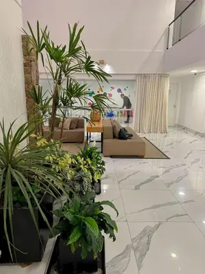 a living room filled with lots of potted plants at Departamento Veneto Village - K - in Villa Parque Siquiman