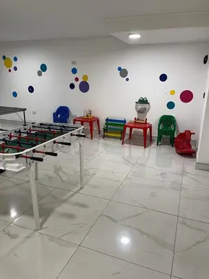 a room with colorful tables and chairs on the wall at Departamento Veneto Village - B in Villa Parque Siquiman