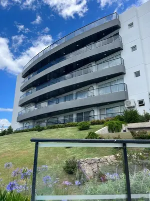 a building with a garden in front of it at Departamento Veneto Village - B in Villa Parque Siquiman