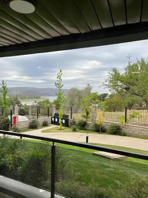 a view of a garden from a window of a house at Departamento Veneto Village - B in Villa Parque Siquiman