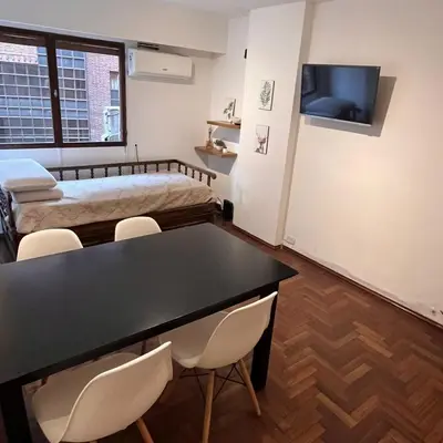 a room with a bed and a table and chairs at Eugenio Garzón 448 in Cordoba