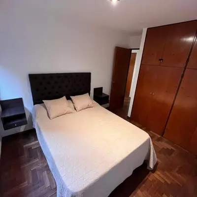 a bedroom with a large bed and a dresser at Eugenio Garzón 448 in Cordoba