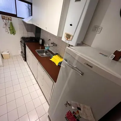 a kitchen with a white refrigerator and a sink at Eugenio Garzón 448 in Cordoba