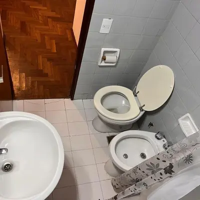 a bathroom with a white toilet and a sink at Eugenio Garzón 448 in Cordoba