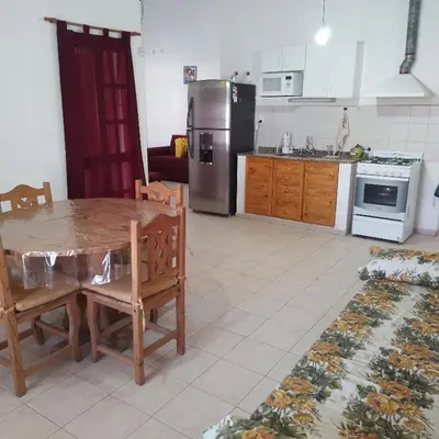 a kitchen with a table and a stainless steel refrigerator at Casa de Julia in Cordoba