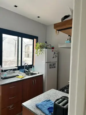 a kitchen with a white refrigerator and a window at Casa Naranja habitaciones privadas in Cordoba