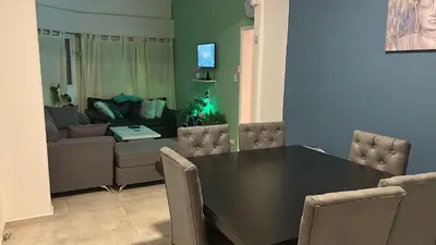a living room with a black table and a couch at Casa Naranja habitaciones privadas in Cordoba