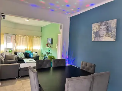 a living room with a table and a couch at Casa Naranja habitaciones privadas in Cordoba