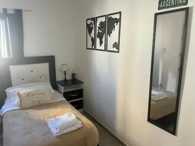 a bedroom with a bed and a large mirror at Casa Naranja habitaciones privadas in Cordoba