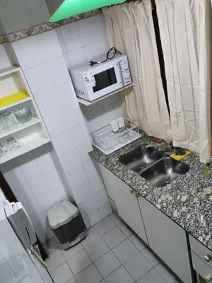 a small kitchen with a sink and a microwave at tu lugar 1 in Cordoba