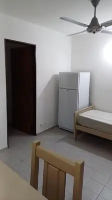 a room with a refrigerator and a bed and a chair at tu lugar 1 in Cordoba